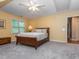 Bedroom with hardwood bed frame, neutral carpet, and natural light at 5401 Fire Pink Way, Raleigh, NC 27613
