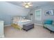 Cozy bedroom featuring a white bed frame, ceiling fan, and attic ceiling at 5401 Fire Pink Way, Raleigh, NC 27613