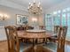 Elegant dining room with hardwood floors, a large chandelier, and traditional furnishings at 5401 Fire Pink Way, Raleigh, NC 27613