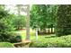 Beautifully landscaped front yard with lush greenery and stately trees at 5401 Fire Pink Way, Raleigh, NC 27613