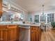 Open concept kitchen with island, breakfast area, and a view into living room with a fireplace at 5401 Fire Pink Way, Raleigh, NC 27613