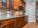Kitchen with hardwood floors, custom cabinets, and granite countertops with stainless steel microwave at 5401 Fire Pink Way, Raleigh, NC 27613