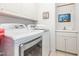 Bright laundry room features modern washer and dryer, sink, cabinets and decor at 5401 Fire Pink Way, Raleigh, NC 27613