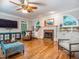 Open-concept living room with a fireplace, ceiling fan, hardwood floors, and beautiful built-in shelving at 5401 Fire Pink Way, Raleigh, NC 27613