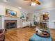 Spacious living room with fireplace, hardwood floors, built-in shelves and a dining area at 5401 Fire Pink Way, Raleigh, NC 27613