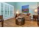 Cozy living room features light blue walls, unique coffee table, and shuttered windows for natural light at 5401 Fire Pink Way, Raleigh, NC 27613