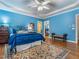 Bedroom featuring hardwood floors, tray ceiling, walk-in closet and comfortable furnishings at 5401 Fire Pink Way, Raleigh, NC 27613