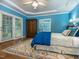 Bedroom featuring hardwood floors, tray ceilings, a ceiling fan and ample natural light at 5401 Fire Pink Way, Raleigh, NC 27613