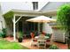 Charming covered patio with brick floor, table and chairs for outdoor dining and relaxation at 5401 Fire Pink Way, Raleigh, NC 27613