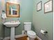 Traditional powder room with pedestal sink, gold mirror, and decorative art at 5401 Fire Pink Way, Raleigh, NC 27613