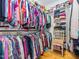 Bright walk-in closet with custom shelving, rods and a vintage chair at 5401 Fire Pink Way, Raleigh, NC 27613