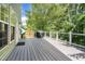 Spacious back deck with gray wood-grain flooring, a grilling area, and a fenced-in yard at 6 Beaver Creek Lane Ln, Durham, NC 27703