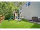 View of the backyard with a large wooden playset for , adjacent to the house with light green siding at 6 Beaver Creek Lane Ln, Durham, NC 27703