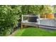Grill on the deck overlooking the lawn that steps down to the grassy area with a view of the trees at 6 Beaver Creek Lane Ln, Durham, NC 27703