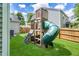 Wooden playset in the backyard with a slide and multiple play areas for entertainment at 6 Beaver Creek Lane Ln, Durham, NC 27703