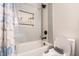 Bathroom featuring a tub with sleek tile, a niche with toiletries, and a toilet with a toddler seat at 6 Beaver Creek Lane Ln, Durham, NC 27703