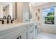 Bright bathroom featuring double sinks, a storage tower, and a large window at 6 Beaver Creek Lane Ln, Durham, NC 27703