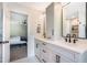 Bright bathroom featuring double sinks, matte black hardware, and an open doorway to the bedroom at 6 Beaver Creek Lane Ln, Durham, NC 27703