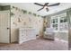A jungle themed Bedroom with a white dresser, cozy recliner, and large window providing natural light at 6 Beaver Creek Lane Ln, Durham, NC 27703