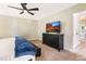 Bedroom featuring a ceiling fan, large television, and a dark wood dresser at 6 Beaver Creek Lane Ln, Durham, NC 27703