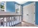 A cozy Bedroom with blue walls, a white crib, and a window that provides natural light at 6 Beaver Creek Lane Ln, Durham, NC 27703