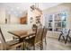 Dining area with a wooden table, modern light fixture, and view into the kitchen at 6 Beaver Creek Lane Ln, Durham, NC 27703