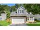 Home featuring a two-car garage, stone accents, and a well-manicured lawn at 6 Beaver Creek Lane Ln, Durham, NC 27703