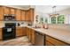 Charming kitchen with stainless steel appliances, light countertops and wood cabinets at 6 Beaver Creek Lane Ln, Durham, NC 27703