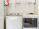 Functional laundry room featuring side-by-side washer and dryer with wire shelving for storage at 6 Beaver Creek Lane Ln, Durham, NC 27703