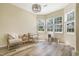 Bright, sunlit room with wood floors, neutral walls, and large windows with views of the yard at 6 Beaver Creek Lane Ln, Durham, NC 27703
