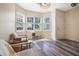 Bright sunlit room with wood floors, neutral walls, and large windows with views of the yard at 6 Beaver Creek Lane Ln, Durham, NC 27703