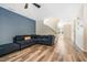 Comfortable living room with blue accent wall, wood floors, and ample natural light at 6 Beaver Creek Lane Ln, Durham, NC 27703