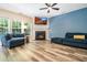 Cozy living room with a fireplace, a mounted television, and comfortable blue furniture at 6 Beaver Creek Lane Ln, Durham, NC 27703