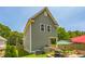 Home's exterior features a green siding, fenced yard, and patio with grills at 647 N Hardee St, Durham, NC 27703