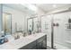 Bathroom features a double sink vanity with chrome fixtures and a tiled walk-in shower at 647 N Hardee St, Durham, NC 27703