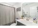 Bathroom featuring a single sink vanity and tiled shower/tub combo at 647 N Hardee St, Durham, NC 27703
