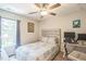 Cozy bedroom with a ceiling fan, desk, and natural light from the window at 647 N Hardee St, Durham, NC 27703