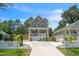 Charming two-story home featuring a welcoming porch, manicured lawn, and a concrete driveway at 647 N Hardee St, Durham, NC 27703