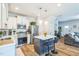 Bright, open kitchen with white cabinets, stainless steel appliances, and a central island with seating at 647 N Hardee St, Durham, NC 27703