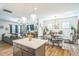 Open concept kitchen and dining area with island, modern lighting and view to the living room at 647 N Hardee St, Durham, NC 27703