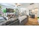 Open-concept living space with a sectional sofa, wood floors, and seamlessly connecting to the kitchen at 647 N Hardee St, Durham, NC 27703