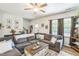 Comfortable living room featuring a large gray sectional sofa, wood-look floors, and natural light at 647 N Hardee St, Durham, NC 27703