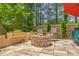 Stone patio area featuring a built-in fire pit, wooden fence, and outdoor seating at 647 N Hardee St, Durham, NC 27703