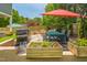 Backyard patio featuring a grill, seating area, and raised garden beds at 647 N Hardee St, Durham, NC 27703