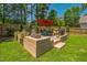 Outdoor patio features a stone fireplace, grill, table, chairs, and decorative planters at 647 N Hardee St, Durham, NC 27703