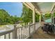 Inviting covered porch with comfortable seating, offering a view of the street and surrounding greenery at 647 N Hardee St, Durham, NC 27703