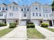 Beautiful townhouses with a well-manicured lawn and individual driveways on a sunny day at 650 Ganyard Farm Way # 41, Durham, NC 27703