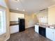 Modern kitchen featuring white cabinetry, stainless appliances, granite counters, and tile floors at 650 Ganyard Farm Way # 41, Durham, NC 27703
