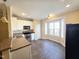 Eat-in kitchen with stainless appliances, granite counters, white cabinets, and tiled flooring at 650 Ganyard Farm Way # 41, Durham, NC 27703