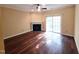 Bright living room featuring a fireplace, ceiling fan, hardwood floors, and sliding glass doors to the outside at 650 Ganyard Farm Way # 41, Durham, NC 27703
